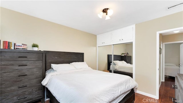 bedroom featuring dark hardwood / wood-style floors and a closet