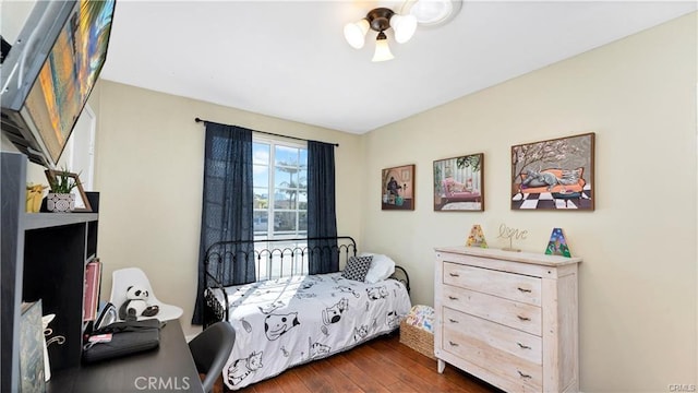 bedroom with dark wood-type flooring