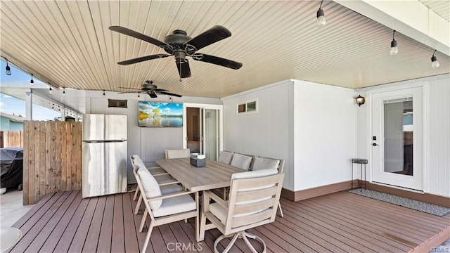 wooden deck featuring ceiling fan