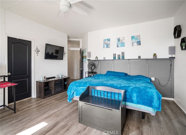 bedroom with light hardwood / wood-style flooring and ceiling fan