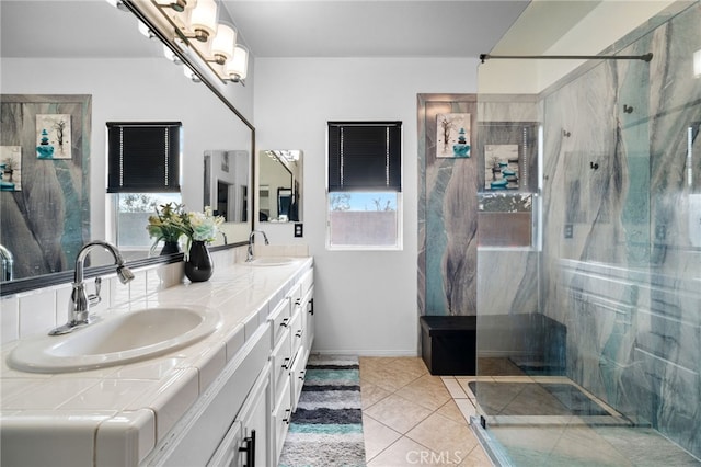 bathroom featuring a healthy amount of sunlight, tiled shower, tile patterned floors, and vanity