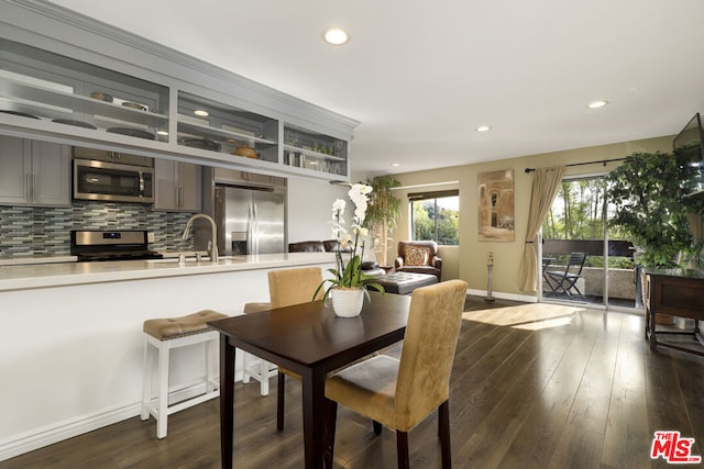 dining area featuring sink and dark hardwood / wood-style floors