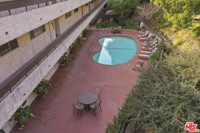 view of swimming pool featuring a patio area