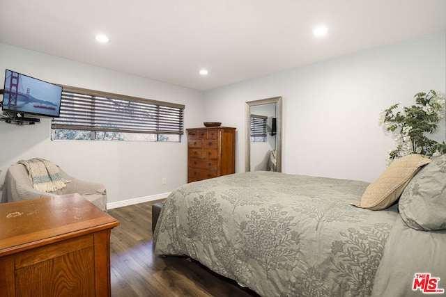 bedroom with dark hardwood / wood-style floors