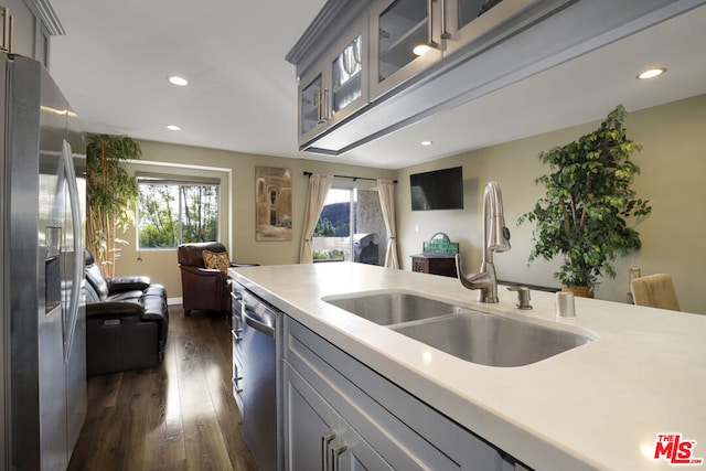 kitchen featuring sink, appliances with stainless steel finishes, dark wood-type flooring, and gray cabinets