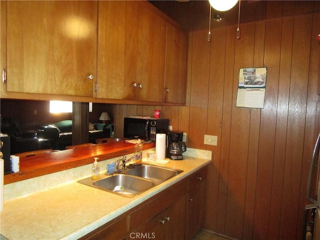 2440 Spruce Dr, Arrowbear, CA 92382 - kitchen with black microwave, brown cabinets, and wooden walls