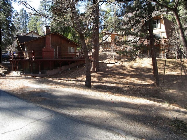 2440 Spruce Dr, Arrowbear, CA 92382 - view of side of home featuring a chimney and a wooden deck