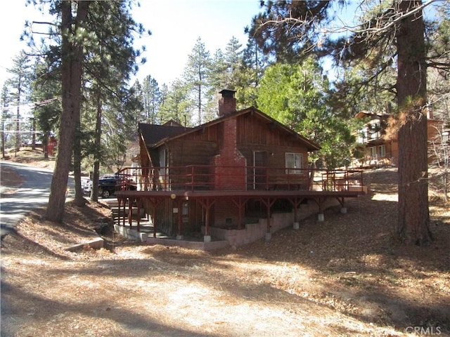 2440 Spruce Dr, Arrowbear, CA 92382 - view of property exterior featuring a chimney and a deck