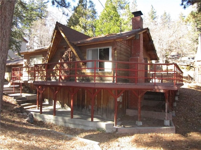2440 Spruce Dr, Arrowbear, CA 92382 - back of house featuring a chimney, a deck, and stairway