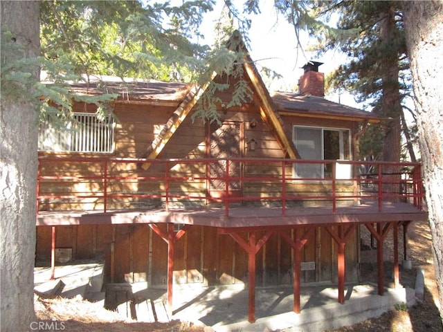 rear view of house featuring a deck