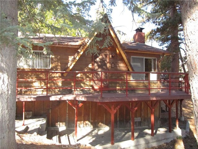 2440 Spruce Dr, Arrowbear, CA 92382 - rear view of property with a chimney and a deck