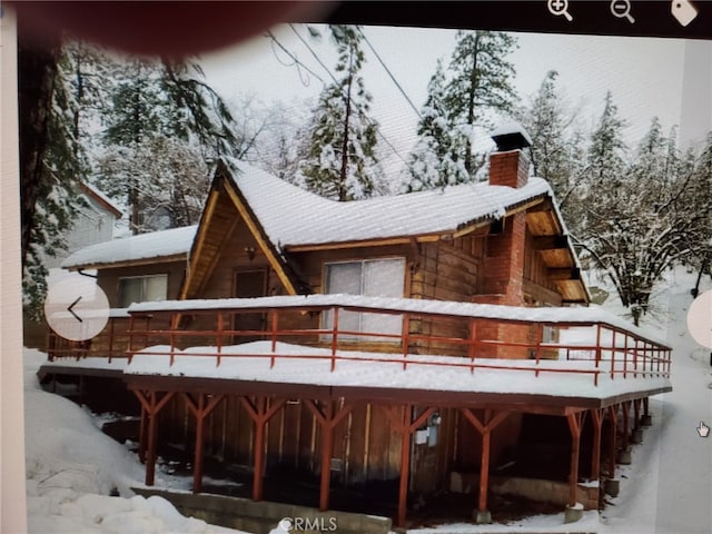2440 Spruce Dr, Arrowbear, CA 92382 - snow covered property with a chimney and a wooden deck