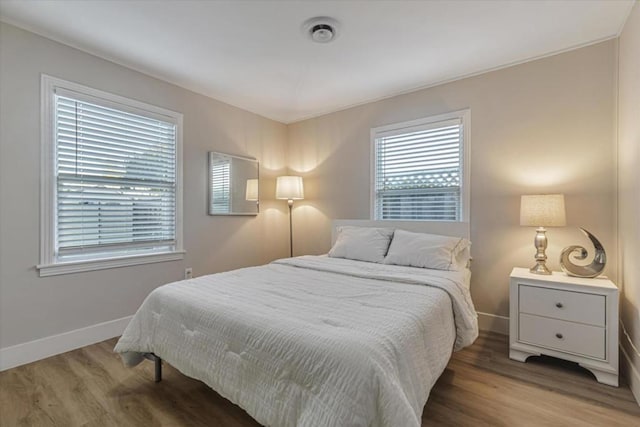 bedroom with hardwood / wood-style floors