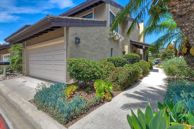 view of side of home featuring a garage