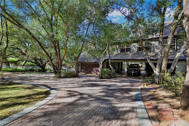 front of property featuring a garage and a carport