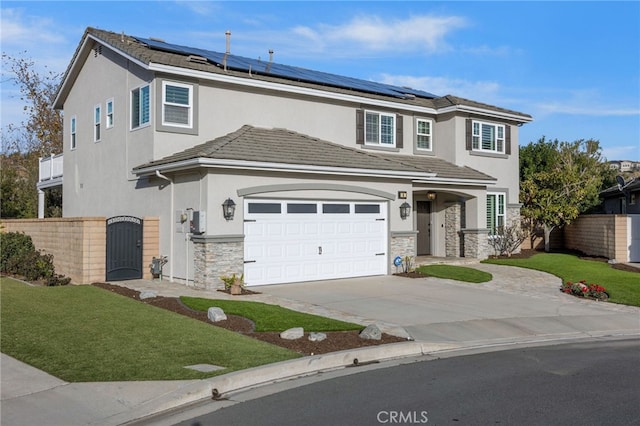 view of front of house with a garage, a front lawn, and solar panels