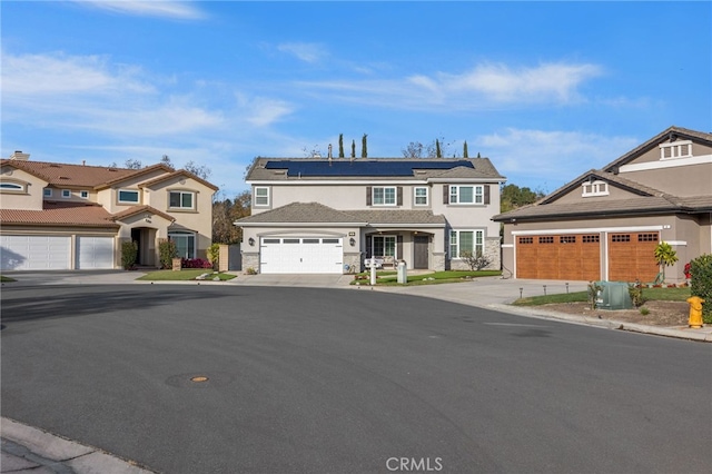 view of front of house with a garage and solar panels