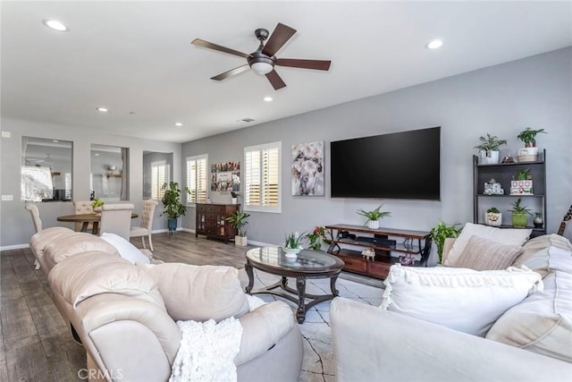 living room with wood-type flooring and ceiling fan