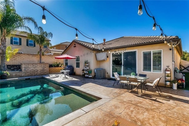 rear view of house with cooling unit and a patio area