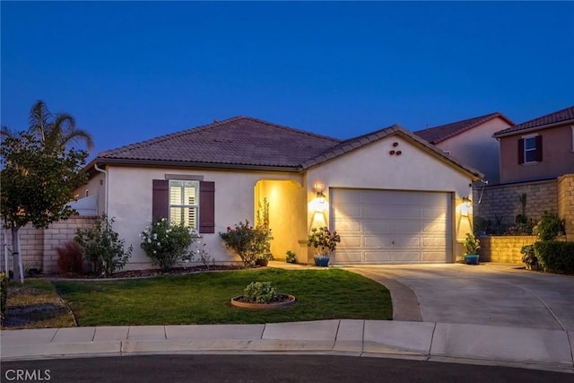 view of front of home with a garage and a front lawn