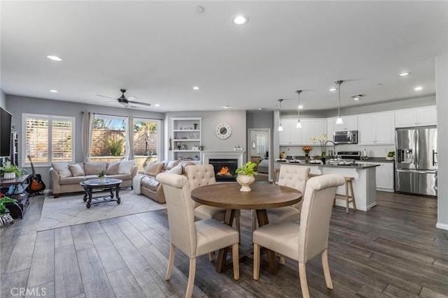 dining room featuring built in features and ceiling fan