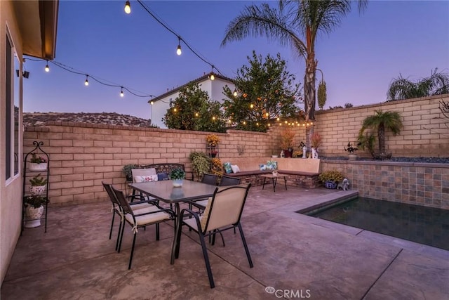 view of patio terrace at dusk