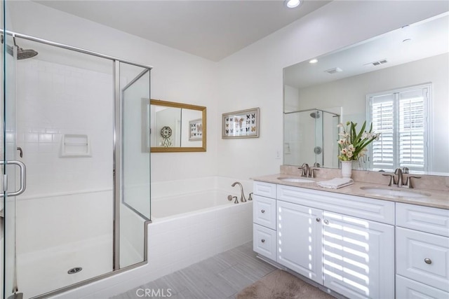 bathroom with vanity and separate shower and tub