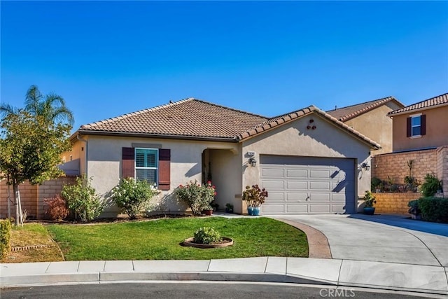 mediterranean / spanish house with a garage and a front yard