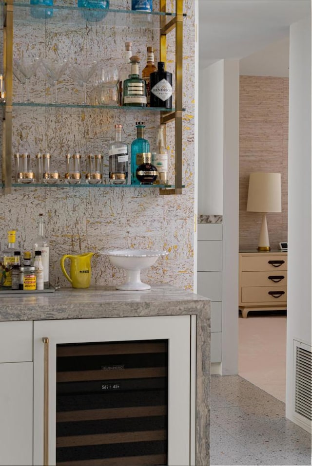 bar with white cabinets and wine cooler