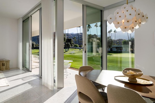 entryway featuring a mountain view and expansive windows