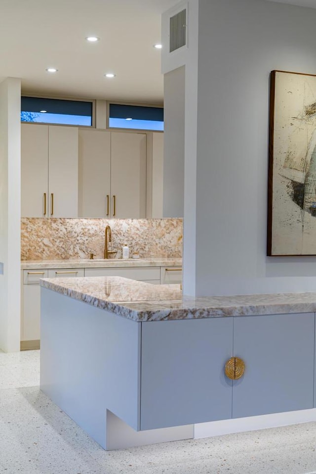 bathroom featuring tasteful backsplash and vanity