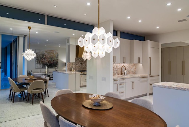 dining space with an inviting chandelier and sink