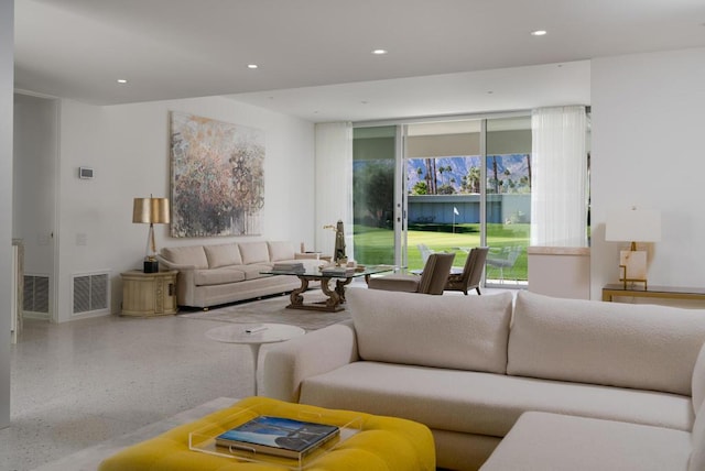 living room featuring plenty of natural light and floor to ceiling windows