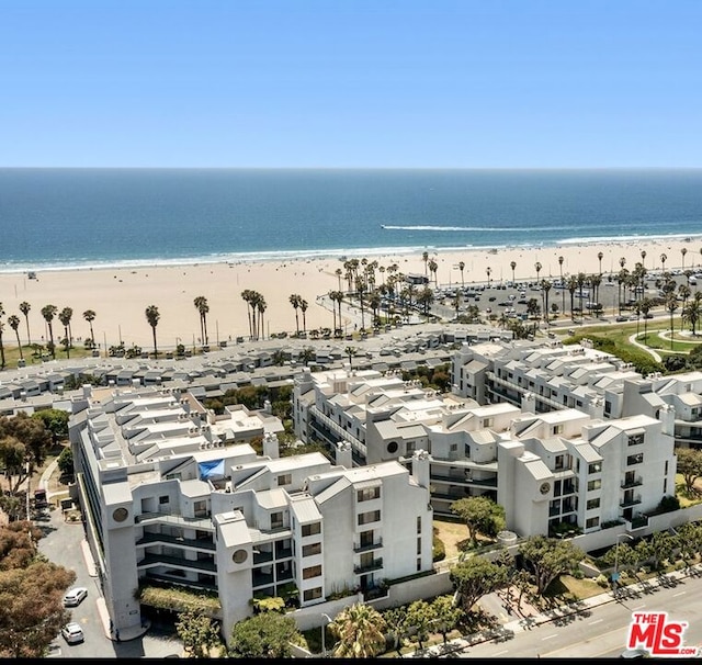 drone / aerial view featuring a view of the beach and a water view