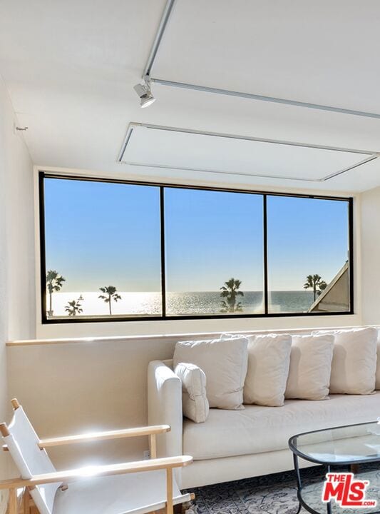 living room featuring a water view and plenty of natural light