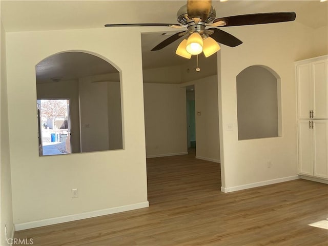 spare room with lofted ceiling, ceiling fan, and light wood-type flooring