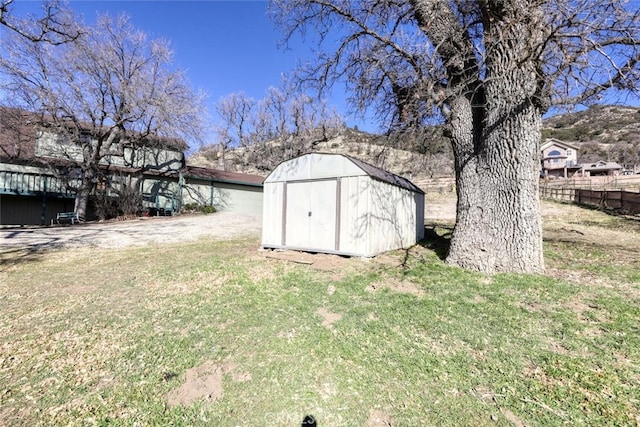 view of outbuilding featuring a lawn