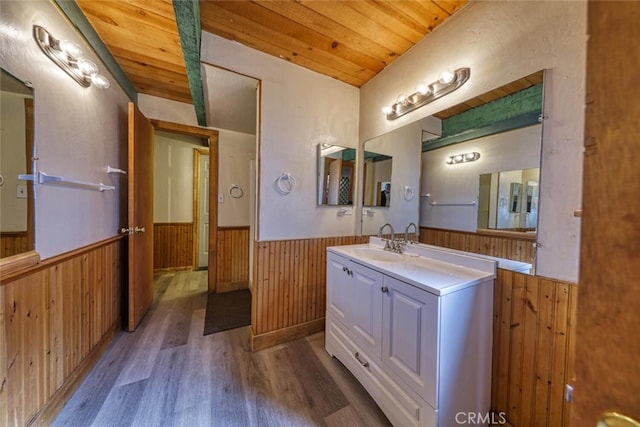 bathroom with wooden ceiling, hardwood / wood-style floors, and vanity