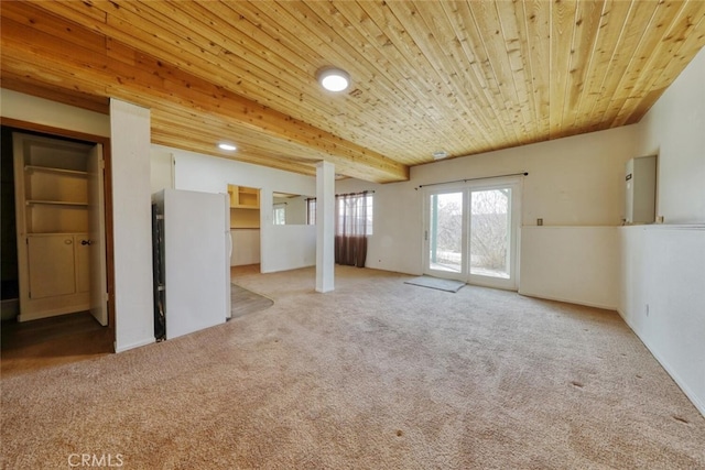 empty room featuring wood ceiling and light carpet