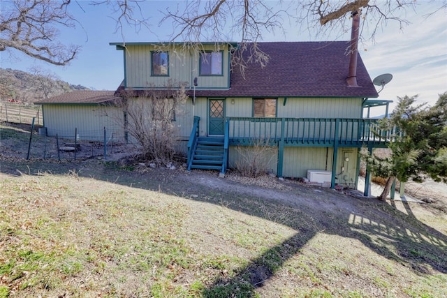 back of house featuring a deck