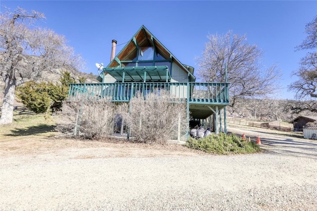 rear view of house featuring a deck