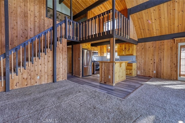 interior space with beamed ceiling, high vaulted ceiling, dark carpet, and wood ceiling