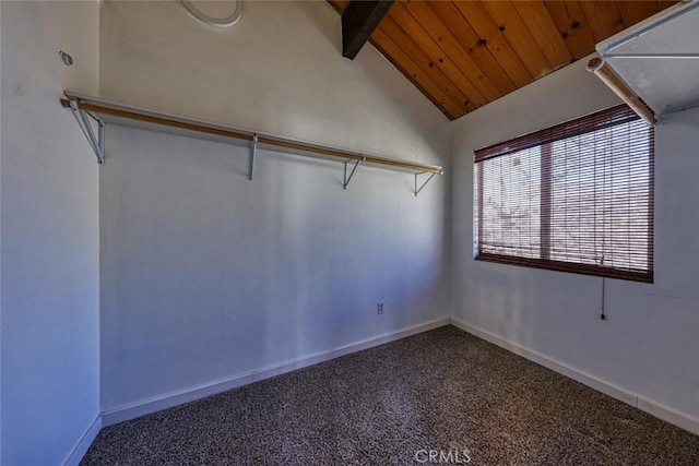 spacious closet featuring lofted ceiling with beams and carpet