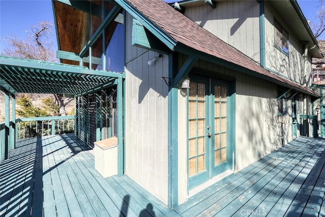 view of home's exterior featuring a wooden deck, a pergola, and french doors