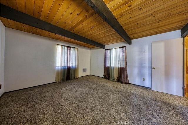 carpeted empty room featuring beam ceiling and wood ceiling