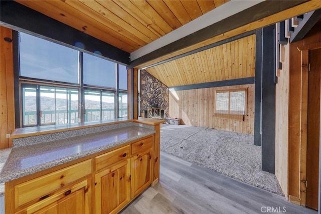 interior space featuring wooden ceiling, light hardwood / wood-style flooring, and vaulted ceiling with beams