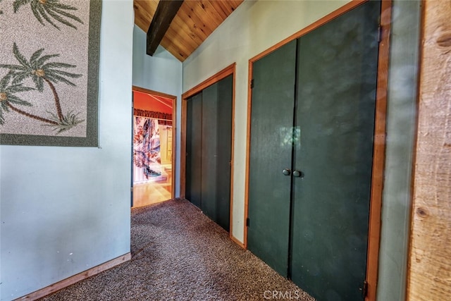 hall featuring vaulted ceiling with beams, carpet, and wood ceiling