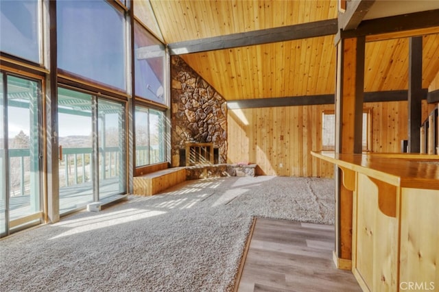 interior space with wood ceiling, high vaulted ceiling, beam ceiling, and light carpet