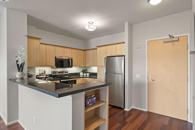 kitchen featuring stainless steel appliances, dark hardwood / wood-style flooring, kitchen peninsula, and light brown cabinets