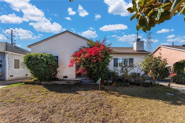 view of side of property with a yard